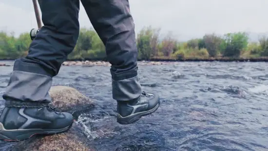 How should wading boots fit when fishing